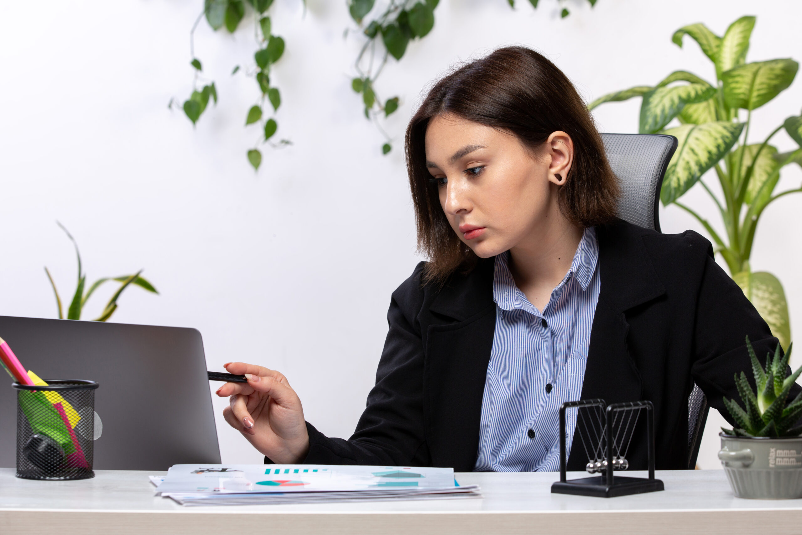 front view beautiful young businesswoman black jacket blue shirt working with laptop front table business job office scaled