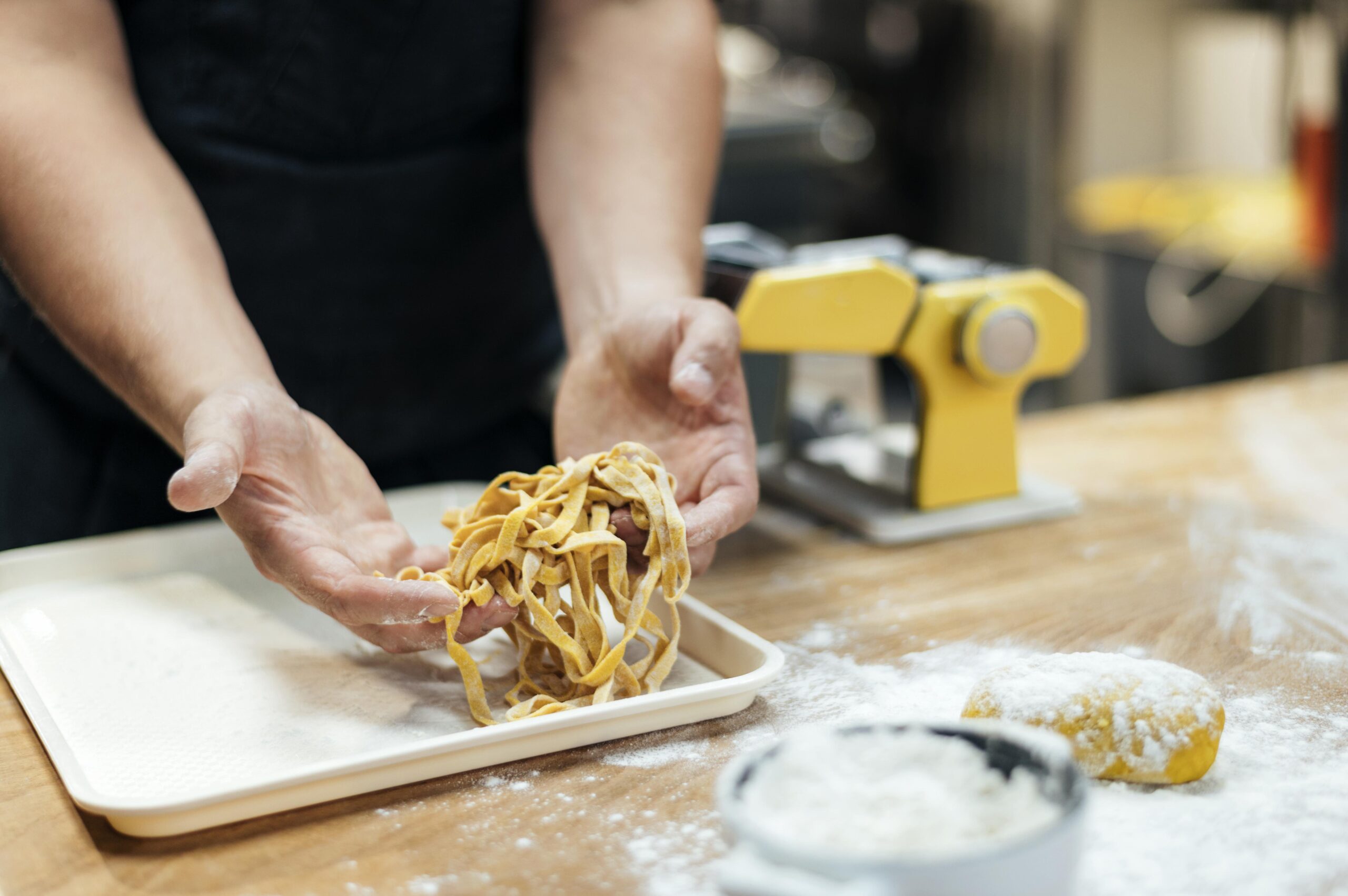 male chef holding fresh pasta scaled