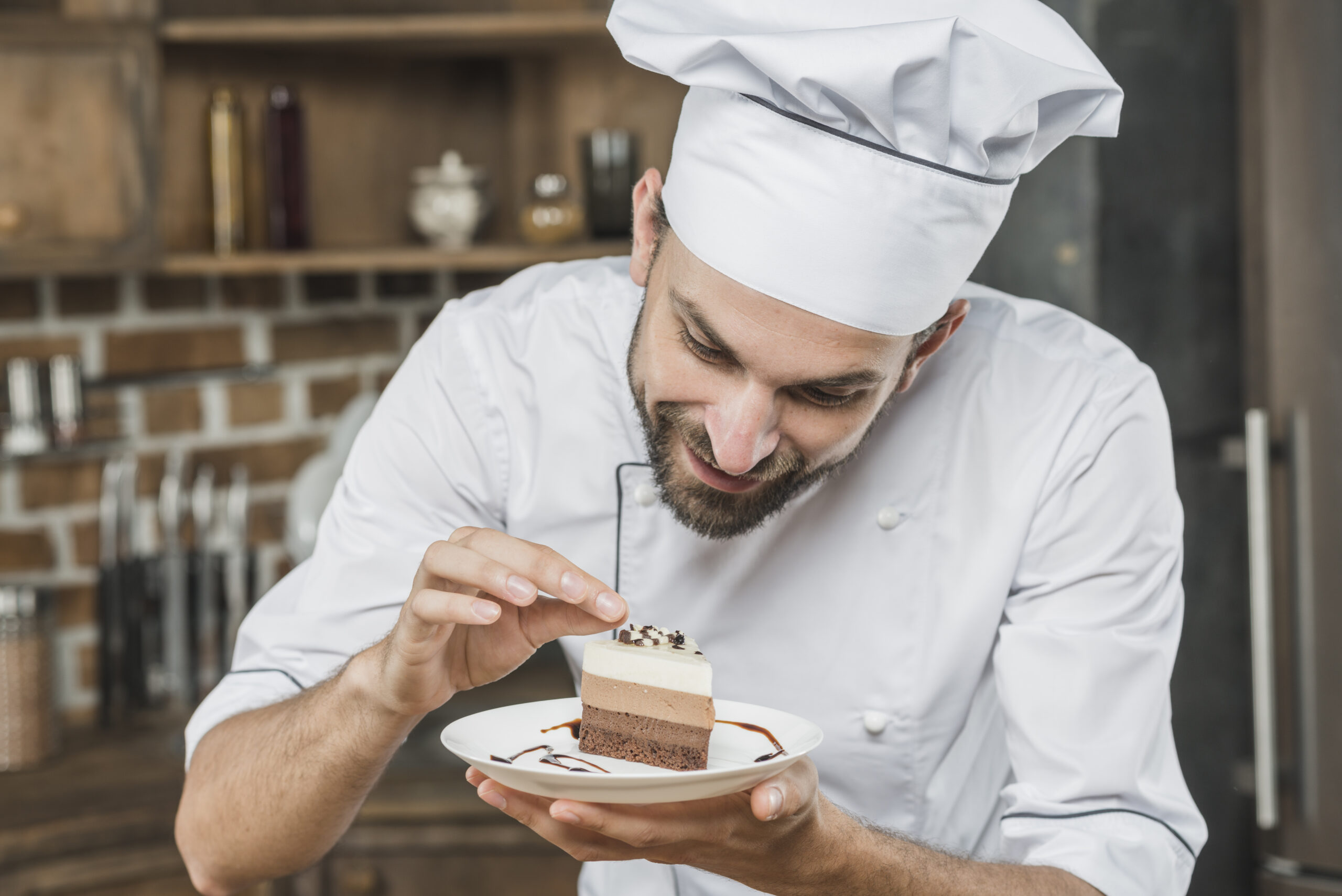 handsome young chef decorating delicious dessert scaled